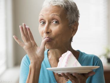 Idősebb nő tortát kóstol