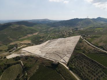 A drone view of the Cretto di Gibellina (also known as "Cretto di Burri") in Sicily, Italy, a town destroyed in the 1968 Belice earthquake.