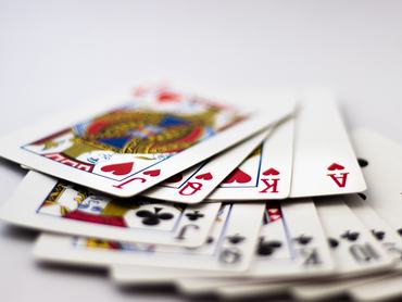 Playing cards with banknotes and coins for gambling