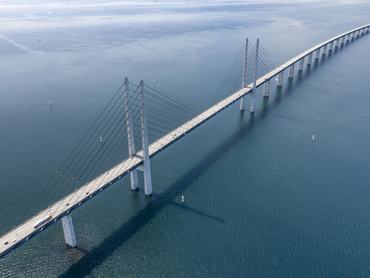 Aerial of the famous Øresund Bridge. The longest combined road and rail bridge in Europe that connects the two major metropolitan areas Copenhagen, the Danish capital city, and the Swedish city of Malmö. Converted from RAW.