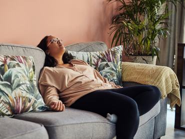 Shot of a young woman resting on the sofa at home