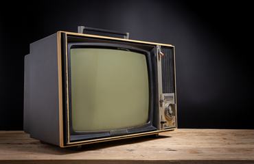 Retro old TV on wooden in dark background, stack photos, vintage tv with copy space