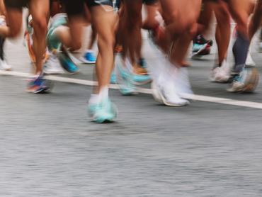 Sports Activities Background. People Running Marathon Distance At The City Street. Banner Horizontal, Ambient Light, Copy Space, Blurred Motion