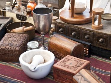 Lot of ancient alchemist instruments, boxes and bottles over a table