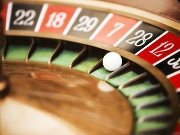 Roulette wheel in casino, close-up on No. 28.