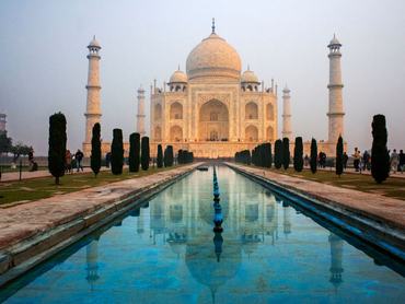 Taj Mahal tomb with reflection in the water at blue dramatic sky in Agra, Uttar Pradesh, India. This is one of the excursion of the Luxury train Maharajas express. (Photo by: Sergi Reboredo/VW Pics/Universal Images Group via Getty Images)