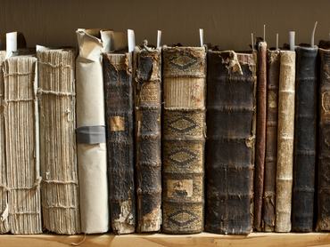 400 year old antique books in a library. Photo was taken at avaible light, for accurate representation of the atmosphere inside.