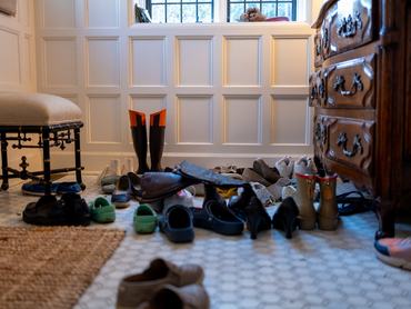 assortment of family’s shoes removed & stored in foyer
