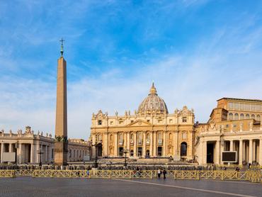 Vatican city landmarks. St. Peter's square and Saint Peter's Basilica in the Vatican in Rome, Italy against blue sky.