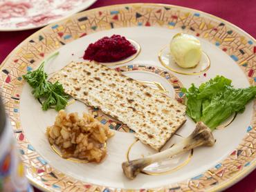 A Passover Seder plate with Charoset, Maror or Bitter Herbs,  Karpas, Zeroah or Lamb Shank, Beitza or Roasted Egg, and Matzoh