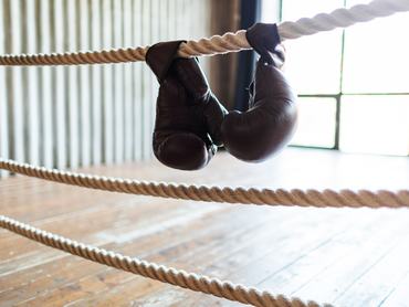 Boxing gloves on ring ropes