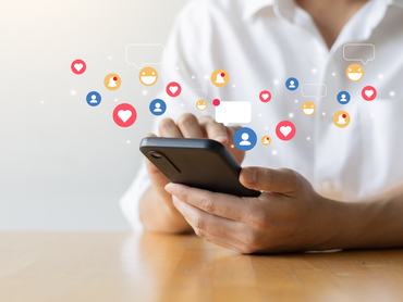 close up man hand hold smartphone and use social media network application to connect or interact with people and friend on online platform with virtual icon symbol for modern lifestyle and communication  concept