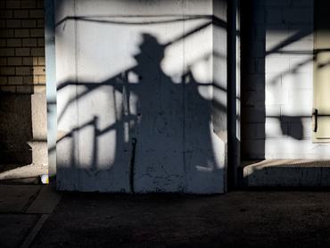Person with backpack casting a shadow.