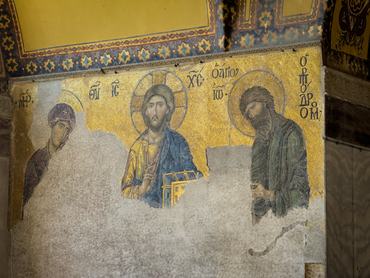 Byzantine Deesis mosaic inside Hagia Sophia, Istanbul, Turkey, showing Christ flanked by Mary and John the Baptist, with golden tesserae and aged plaster