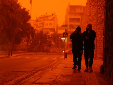 CRETE, GREECE - APRIL 1: People cover themselves to protect from dust as Crete is cloaked by Saharan dust storm in Greece on April 1, 2026. (Photo by Stefanos Rapanis/Anadolu via Getty Images)
