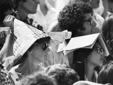 25th June 1976:  Spectators at Wimbledon Tennis Championships protect themselves from the sun wearing newspaper hats and books on their heads, during the heatwave.  (Photo by Graham Wood/Evening Standard/Getty Images)