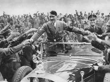 1933:  Adolf Hitler (1889 - 1945), chancellor of Germany, is welcomed by supporters at Nuremberg.  (Photo by Hulton Archive/Getty Images)