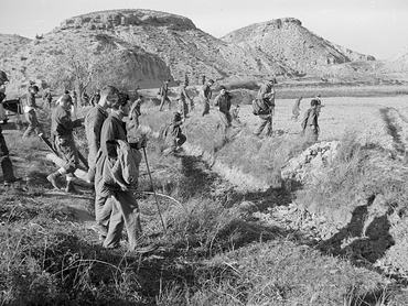 (Original Caption) U.S. airmen scour rugged countryside for a missing nuclear device, during fourth day of operation "Broken Arrow," here January 21st. The weapon was one of four on board a SAC B-52 bomber which crashed January 17th. Officials said there is no danger of a nuclear blast or radiation contamination as a result of the crash.