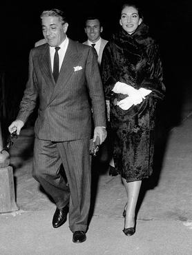 (Original Caption) 9/9/1959- Milan, Italy: Callas confirms marriage breakup. Opera star Maria Meneghini Callas walks with Greek shipping magnate Aristotle Onassis, shortly after his arrival by private plane at Bresso airport near here, Sept 3rd late the couple had dinner at a local night club. On Septmeber 9th the temperamental diva confirmed that her 10-year marriage to Italian millionaire Battista Meneghini is on the rocks. She said there would be a legal separation. She said her desire for a movie career caused the breakup and not her alleged romance with Onassis.