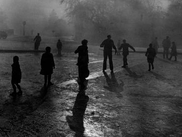 Fog and ice on Hampstead Heath. Boys sliding on the ice in the fog at Hampstead Heath ponds. Although the weather was wintry and the fog was thick, the usual crowd of small boys just naturally gravitated to the ponds on Hampstead Heath when the word went out that the ice was thick enough to stand on. There despite the wintry conditions, 30 odd small boys with the usual supply of small dogs had a wonderful time sliding on the ice, 7th December 1952. (Photo by Phil Dye/Daily Mirror/Mirrorpix/Getty Images)
