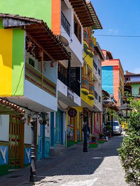 Colorfully-painted buildings along a cobblestone street in the tourist town of Guatape, Colombia. (Photo by: Jon G. Fuller/VW Pics/Universal Images Group via Getty Images)