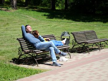 KISLOVODSK, RUSSIA - 2023/05/18: A couple seen relaxing on a bench and enjoying the sun in the Kislovodsk National Park, Russian Federation. Kislovodsk National Park is a specially protected natural area in the city of Kislovodsk. The largest city park in Europe. The area is 965.8 hectares. (Photo by Maksim Konstantinov/SOPA Images/LightRocket via Getty Images)