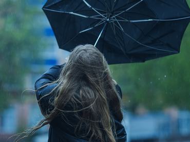 Woman under umbrella. Rainy weather
